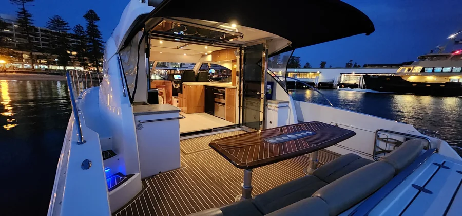 SEADUCTION’s warmly lit aft deck at dusk