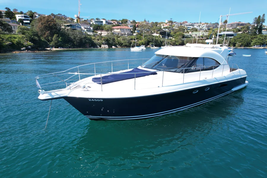 SEADUCTION’s white Riviera superstructure and navy hull on Sydney Harbour